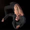 Man In Dynamic Acrobatic Pose Shirtless With Black Pants And Jacket Against Black Background