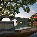 Ancient Architecture With Stone Bridge Old Tree Wooden Boat And Red Buildings By Calm Water