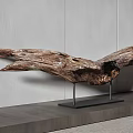 Wooden Eagle Sculpture With Spread Wings On Black Metal Stand Against Gray Wall