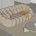 Cozy Two-Seater Sofa With Soft Pillows Blanket On Light Rug And Round Coffee Table