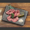 Sliced Raw Beef with Broccoli Lemon Slice and Salt on Black Plate Over Wooden Board