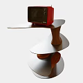 A Spiral Designed Coffee Table With Wooden Structure White Top And Red Microwave