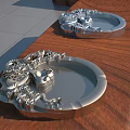 Silver Metal Trays With Intricate Dragon Designs Placed On Wooden Table Surface