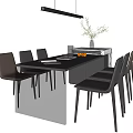 Modern Kitchen Dining Space With Island Table Dark Countertop Chairs Hanging Light And Fruit Decor