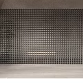 Black Grid Like Partition In Indoor Space With Gray Walls Light Colored Floor And Plant