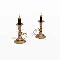 Ornate Metal Candlesticks With Lit Black Candles And Carved Handles Design