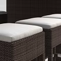 Brown Woven Bar Counter with Black Top and Four Stools Featuring White Cushions Silver Legs