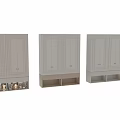 Light Colored Decorative Cabinet With Paneled Doors Brass Handles Open Lower Shelf And Decorative Spheres