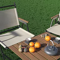 Outdoor Garden Table and Canvas Chairs Set With Fruits and Tea on Grass