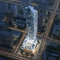 Aerial View of Modern Office Building with Bright Lights Near Urban City Intersection at Night