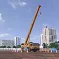 Yellow Crane Utility Vehicle Operating At Construction Site With High Rise Buildings And Traffic Cones