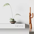 Bonsai Potted Fern Plant In Clay Pot On White Shelf With Orange Decorative Figure