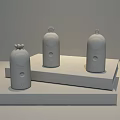 Three Different Colored Small Daily Electrical Appliances With Decorative Tops On Yellow Display Stands