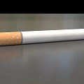 Cigarette With Orange Filter White Body And Black Burned End On Smooth Surface 3d model