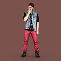 Man Wearing Black Cap Denim Vest And Red Pants On Brown Background