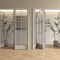 Modern Glass Folding Doors With Metal Frames And Potted Plants On Wooden Floor
