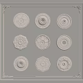Various Decorative Ceiling Medallions with Ornate Patterns and Circular Designs on White Framed Wall
