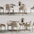 Modern Dining Table And Chair Set With Six Light Colored Chairs And Flower Vase