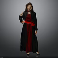 Woman In Black Coat And Red Dress With Red Belt Standing Against Gray Background