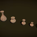 Handcrafted Ceramic Vessels Arranged in Various Sizes Shapes and Earthy Brown Tones on Dark Background