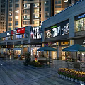 Vibrant Commercial Street With High Rise Buildings Retail Stores Billboards Outdoor Seating and Evening Lights