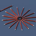 Red Pens Radially Arranged With One Single Pen On Blue Background