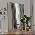 Large Gold Framed Mirror In Living Room With White Fireplace And Green Plant