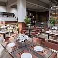 Modern Restaurant Interior With Pink Chairs Green Plants And Pendant Lights