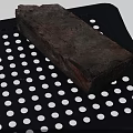 Rustic Textured Stone Brick Placed On Black Perforated Tray Closeup View