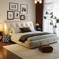 Beige Upholstered Double Sofa in Bedroom with Framed Pictures Table Lamp and Green Throw