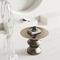 Modern Round Metallic Coffee Table With Coffee Cup Book And Geometric Decor In Minimalist Space