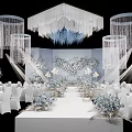 Elegant Wedding Venue Decoration With White Tables Floral Arrangements And Crystal Chandeliers