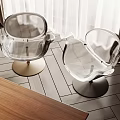Transparent Accent Chairs with Gold and Black Bases on Wooden Floor with Curtains