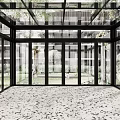 Glass Enclosed Sunroom With Patterned Floor And Outdoor View