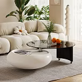Modern Beige Sofa And Coffee Table Set With Curved Design Flower Cushions And Green Plants