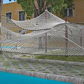 Kindergarten Outdoor Play Area With Net Climbing Structure Tree And Colorful Ground