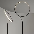 Sleek Modern Floor Lamp Featuring Circular Light Ring And Black Metal Stand In Minimalist Interior