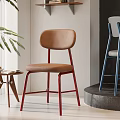Modern Dining Chair Featuring Brown Upholstered Seat And Red Metal Legs In Minimalist Interior