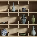 Various Traditional Ceramic Vessels Vases And Bowls Displayed On Wooden Shelf