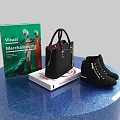 Decorative Accessories Display Set with Books Handbag and Boots on Blue Round Display Stand