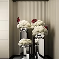 White and Red Flowers in Silver Vases on Black Pillars with Striped Wall Background