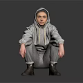 A Man Wearing Gray Hoodie And Gray Pants Squatting On Black Floor With Gray Background