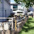 Outdoor Restaurant Seating Area With Trees Umbrella Stone Steps And Greenery