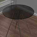 Modern Round Dining Table With Glass Top And Metal Legs On Wooden Floor