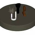 Round Dark Gray Coffee Table With Decorative Sculptures Dried Plant And Modern Ornaments