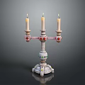 Decorative Candelabra With Three Lit Candles And Colorful Accents On Base