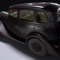 Vintage Black Car with Retro Grille Headlights and Old Tires on Gravel Ground