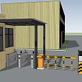 Entrance Gate With Security Booth Barrier Gate And Yellow Industrial Building Under Blue Sky