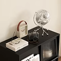 Black Display Cabinet with Globe Camera and Magazines on Open Shelves