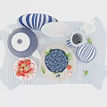 Fresh Blueberries and Strawberries in White Bowl with Blue White Striped Tablecloth and Ceramic Dishes
